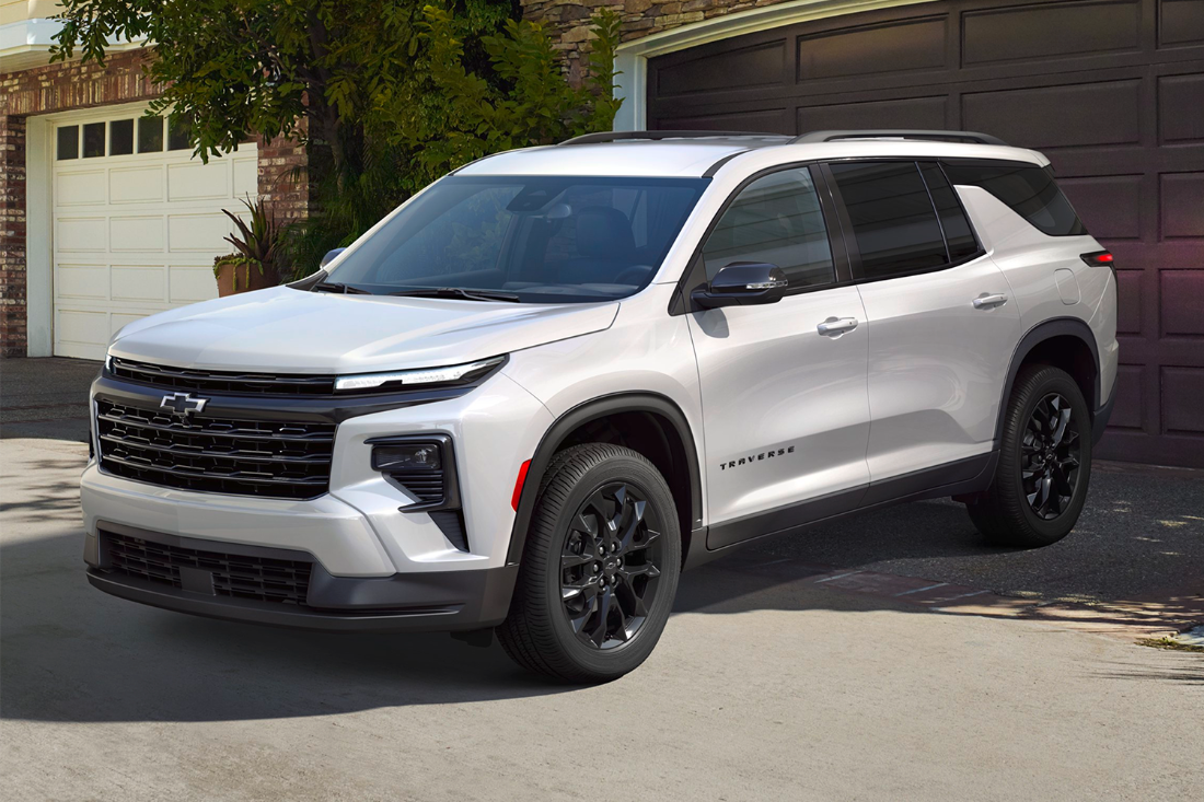 A silver Chevrolet Traverse parked in a driveway.